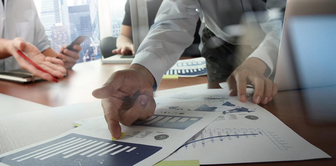 Double exposure of businessman hand working with new modern computer and business strategy as concept