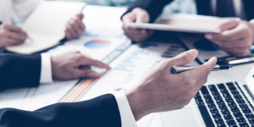 Business adviser analyzing financial figures denoting the progress in the work of the company